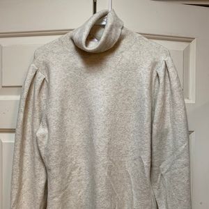 Oatmeal/cream turtleneck sweater.